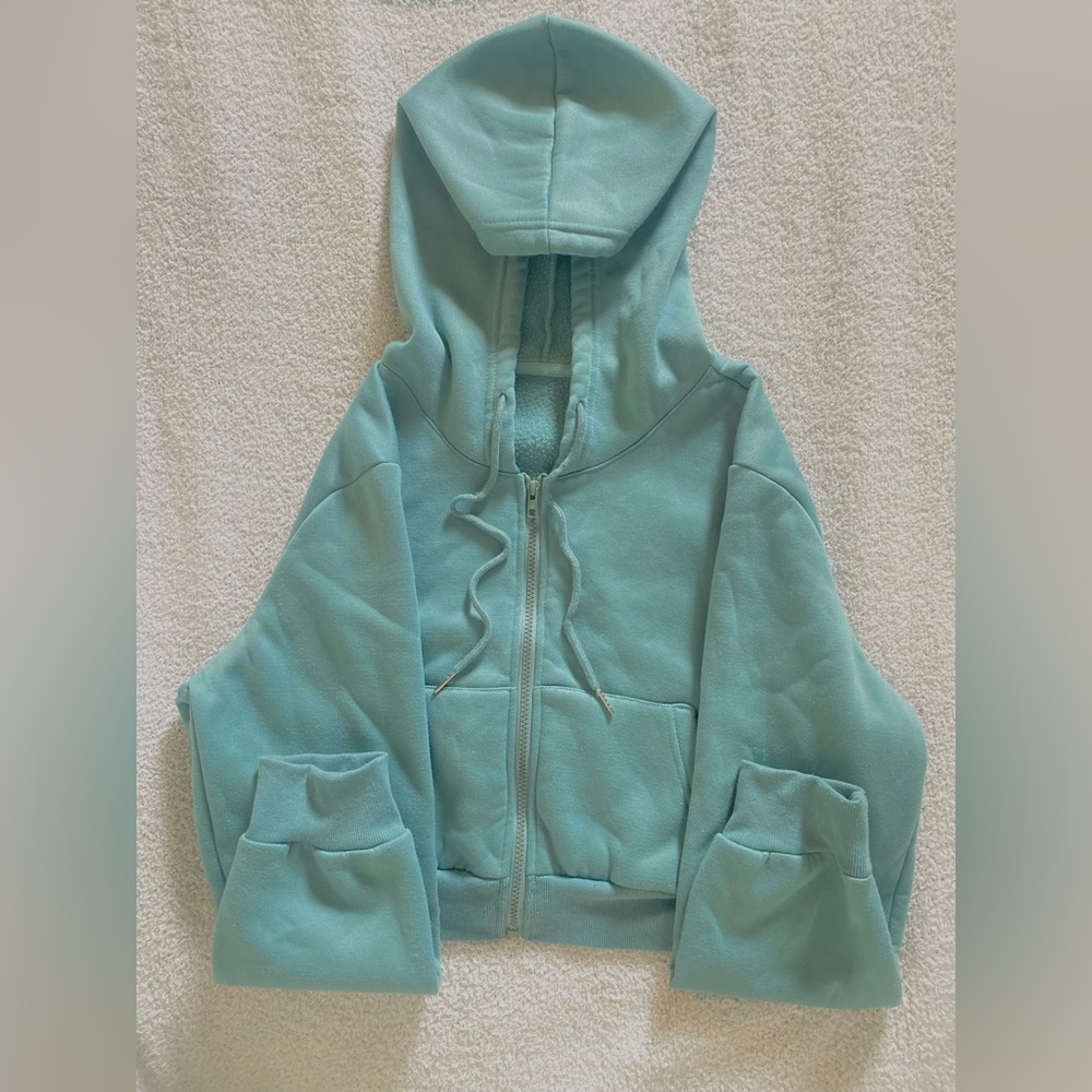 This is a one time worn green/blue zip up in very good condition.